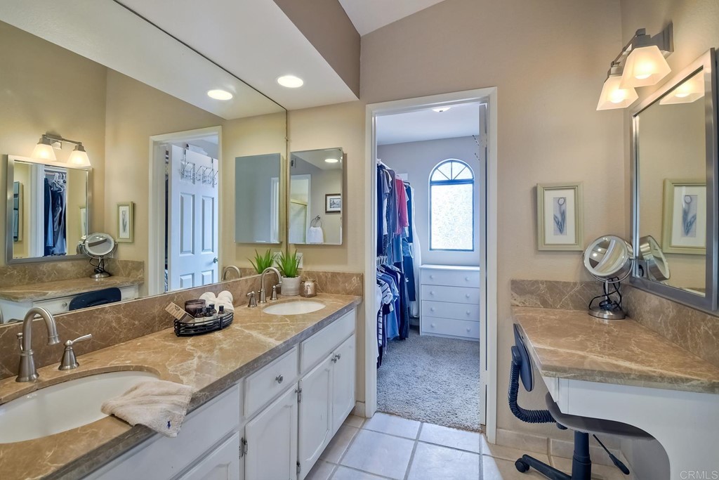 2754 Olympia Drive Carlsbad, CA 92010 - Photo 22 of 35 a bathroom with double vanity sinks double vanity tub shower and a mirror