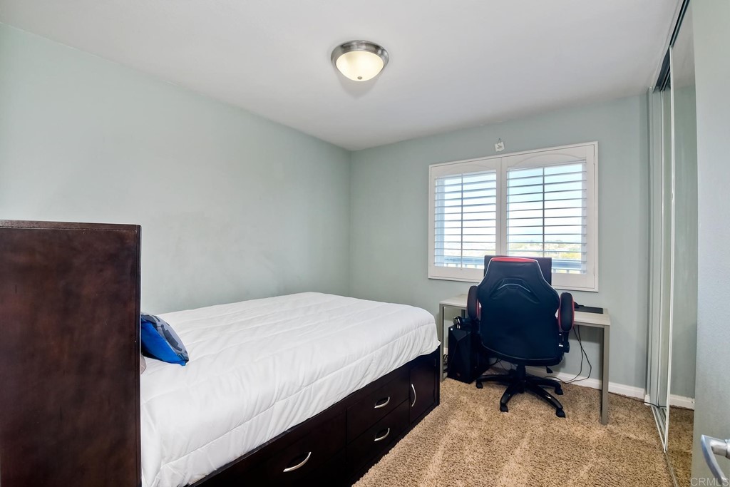 2754 Olympia Drive Carlsbad, CA 92010 - Photo 28 of 35 a bedroom with a bed and a chair