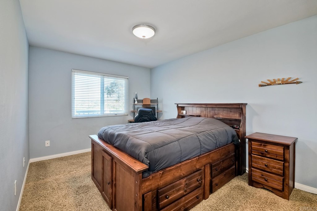 2754 Olympia Drive Carlsbad, CA 92010 - Photo 29 of 35 a bedroom with a bed and dresser