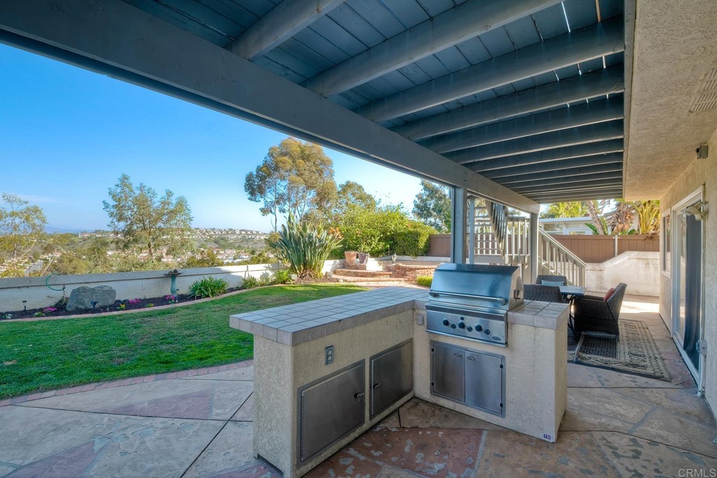 2754 Olympia Drive Carlsbad, CA 92010 - Photo 32 of 35 a open kitchen with stainless steel appliances granite countertop a sink a stove and a yard