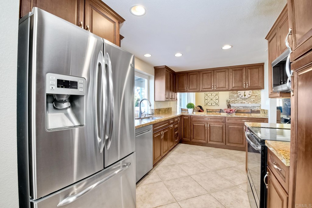 2754 Olympia Drive Carlsbad, CA 92010 - Photo 7 of 35 a kitchen with a refrigerator sink and cabinets