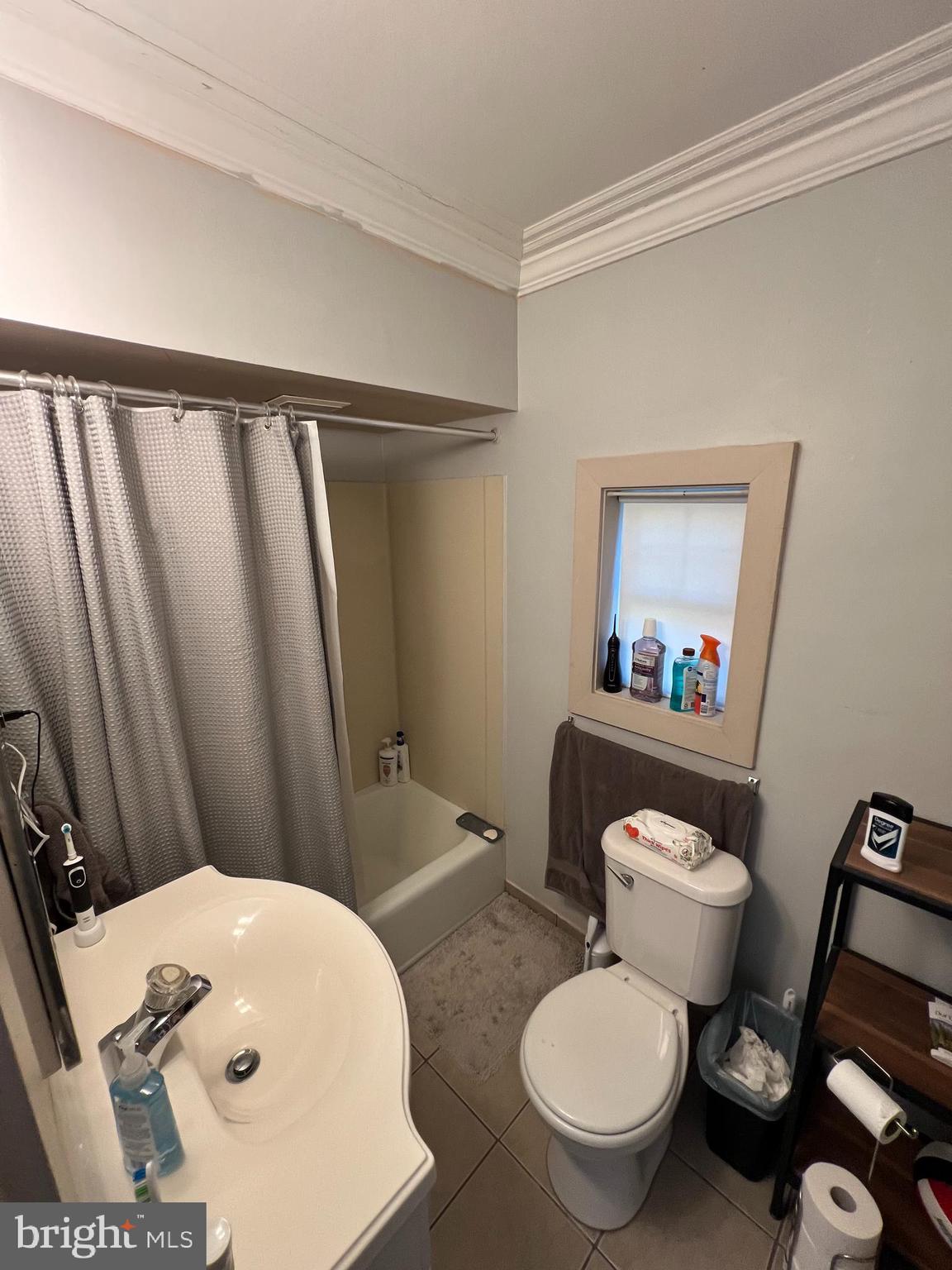 16 Lincoln Avenue, Unit 3 Haddonfield, NJ 08033 - Photo 8 of 8 a white toilet sitting next to a bathroom sink and a mirror