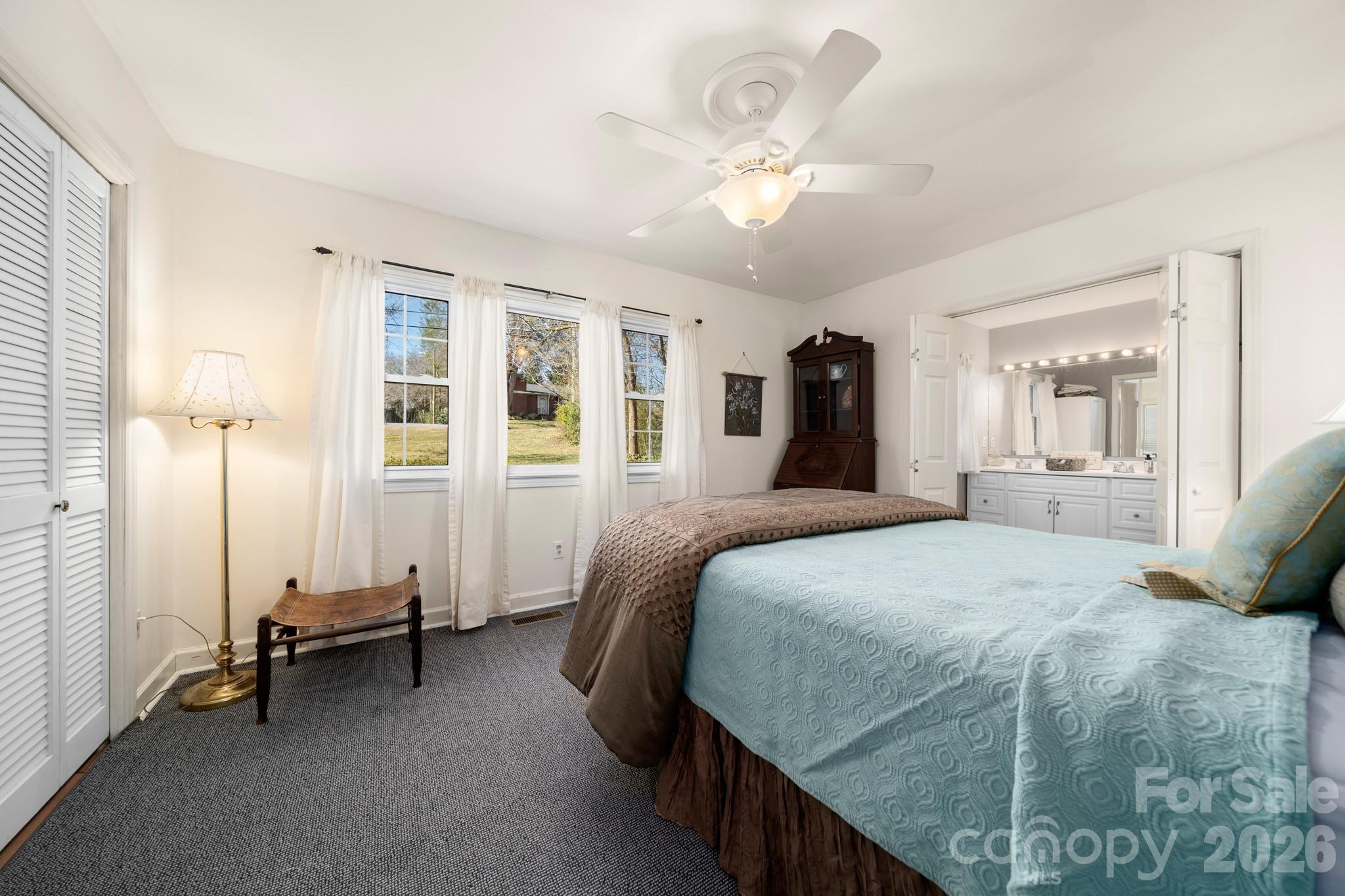 186 Tanner Street Rutherfordton, NC 28139 - Photo 14 of 39 a bedroom with a bed and a chandelier