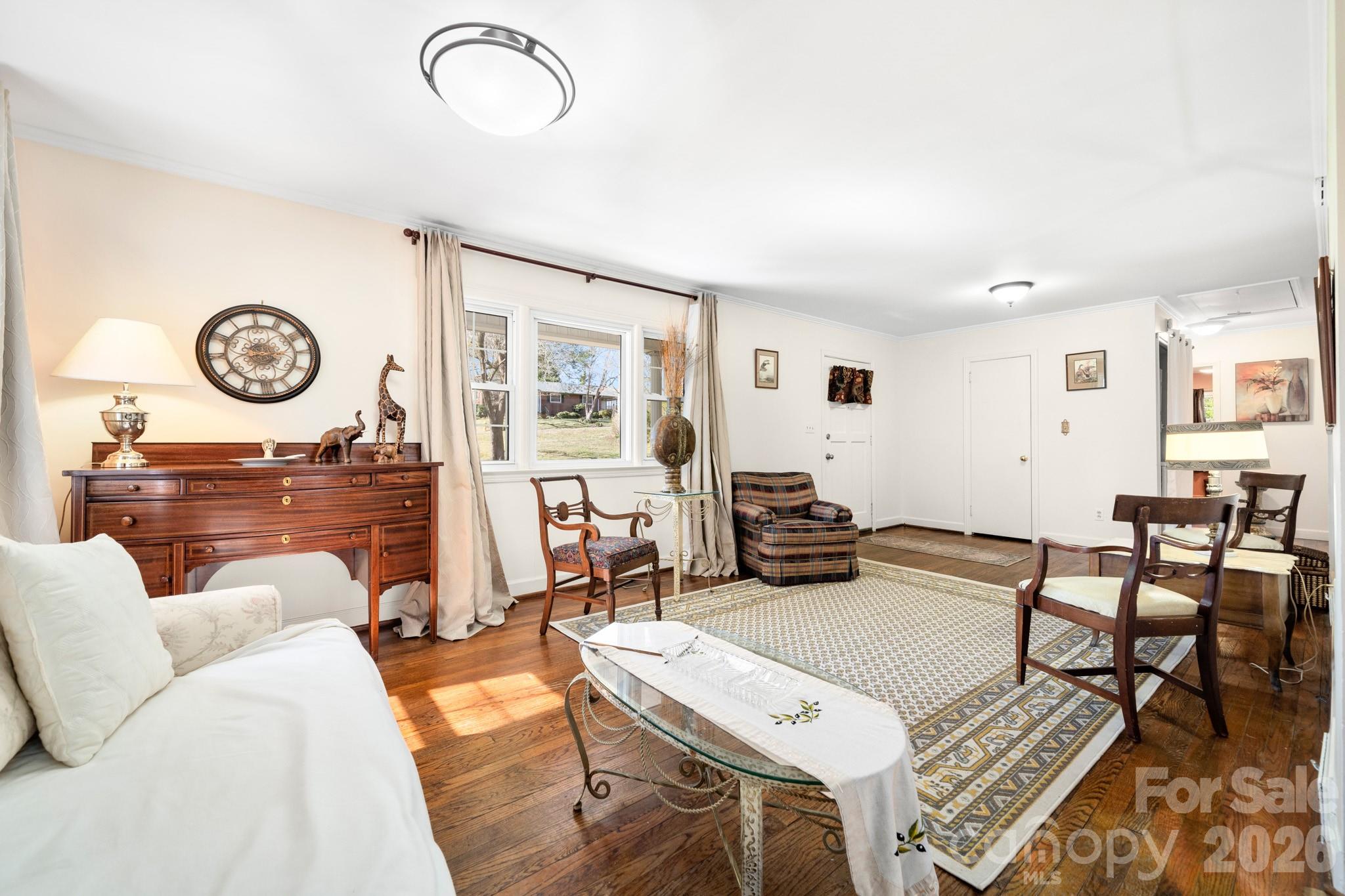 186 Tanner Street Rutherfordton, NC 28139 - Photo 7 of 39 a living room with furniture a clock on wall and a window