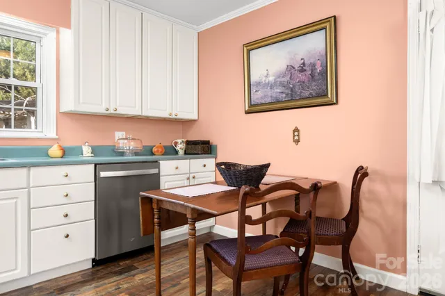 a kitchen with granite countertop white cabinets and white appliances