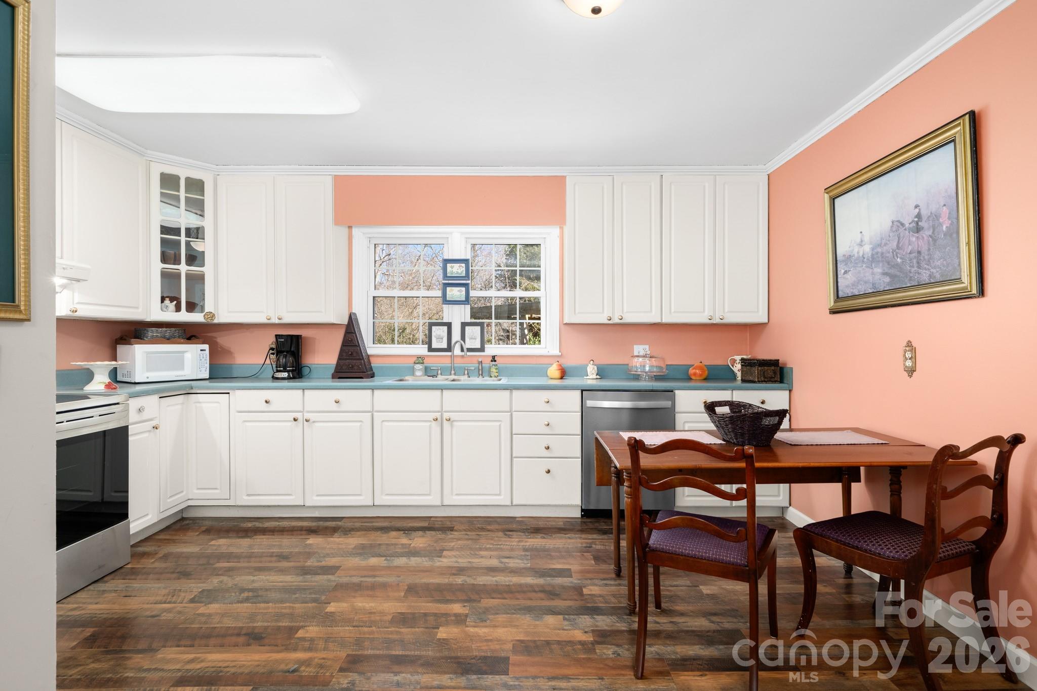 186 Tanner Street Rutherfordton, NC 28139 - Photo 10 of 39 a kitchen with a dining table chairs and white appliances