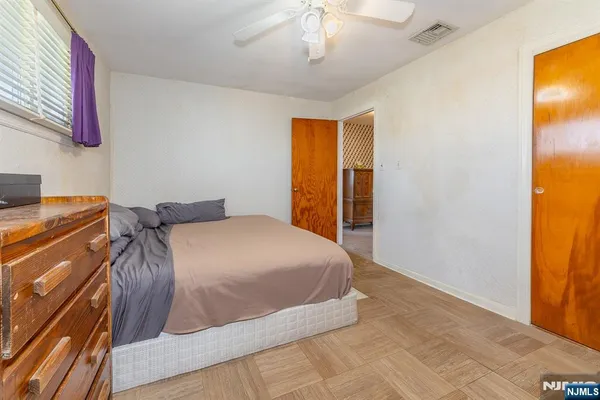 a bedroom with a bed and a window