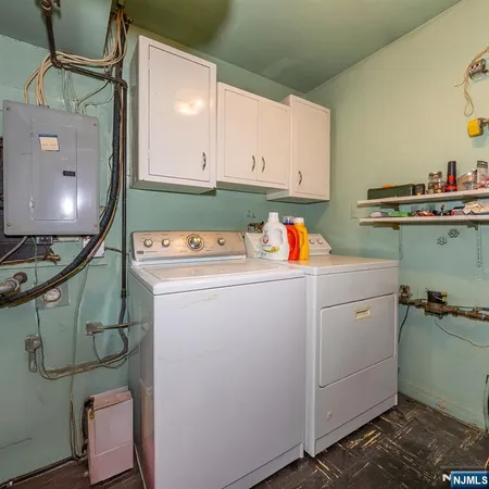 a utility room with cabinets washer and dryer