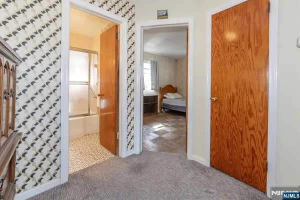 a view of a hallway to a livingroom with furniture