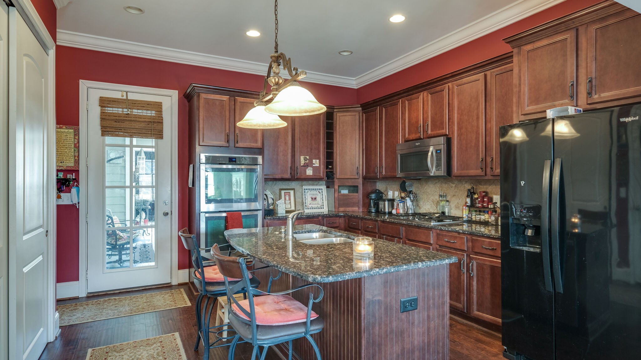 1011 Rural Plains Circle Franklin, TN 37064 - Photo 4 of 36 a kitchen with kitchen island granite countertop a sink cabinets and outdoor space