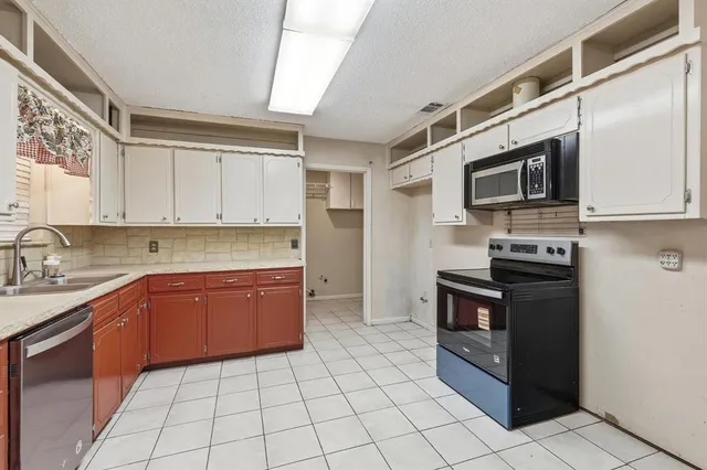 a kitchen with stainless steel appliances granite countertop a stove and a sink