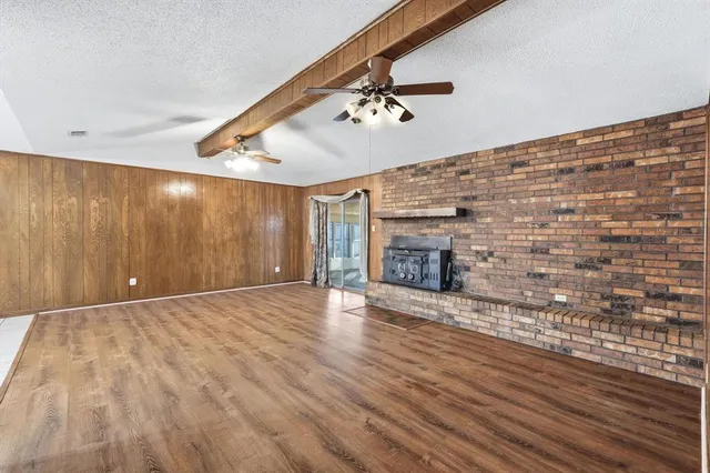 a view of an empty room with a fireplace