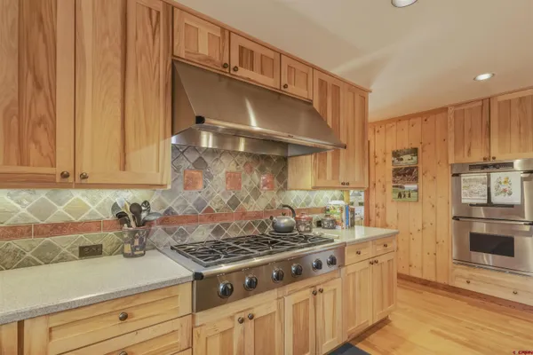 a kitchen with stainless steel appliances granite countertop a stove and a refrigerator