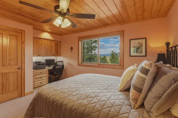 a bedroom with a bed dresser and a window