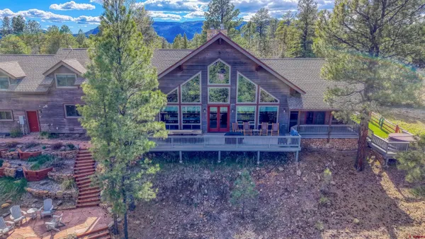 an aerial view of a house with a yard