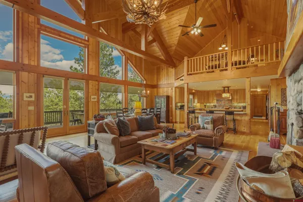 a living room with furniture a rug and a large window