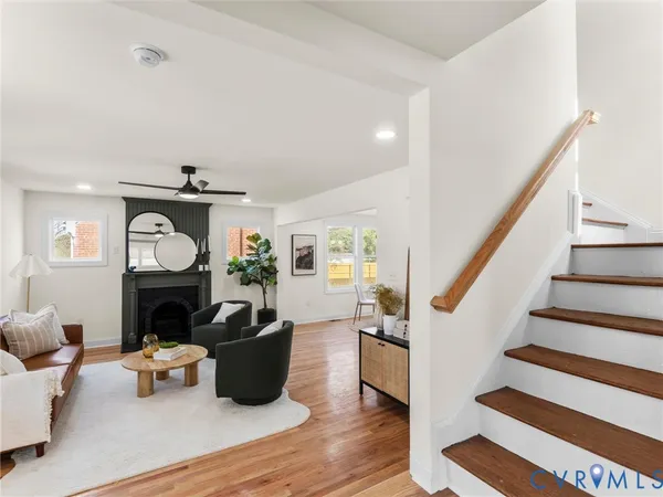 a kitchen with stainless steel appliances granite countertop a sink a stove a refrigerator cabinets and a window