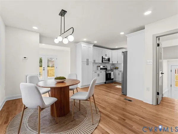 a kitchen with stainless steel appliances a stove microwave and sink