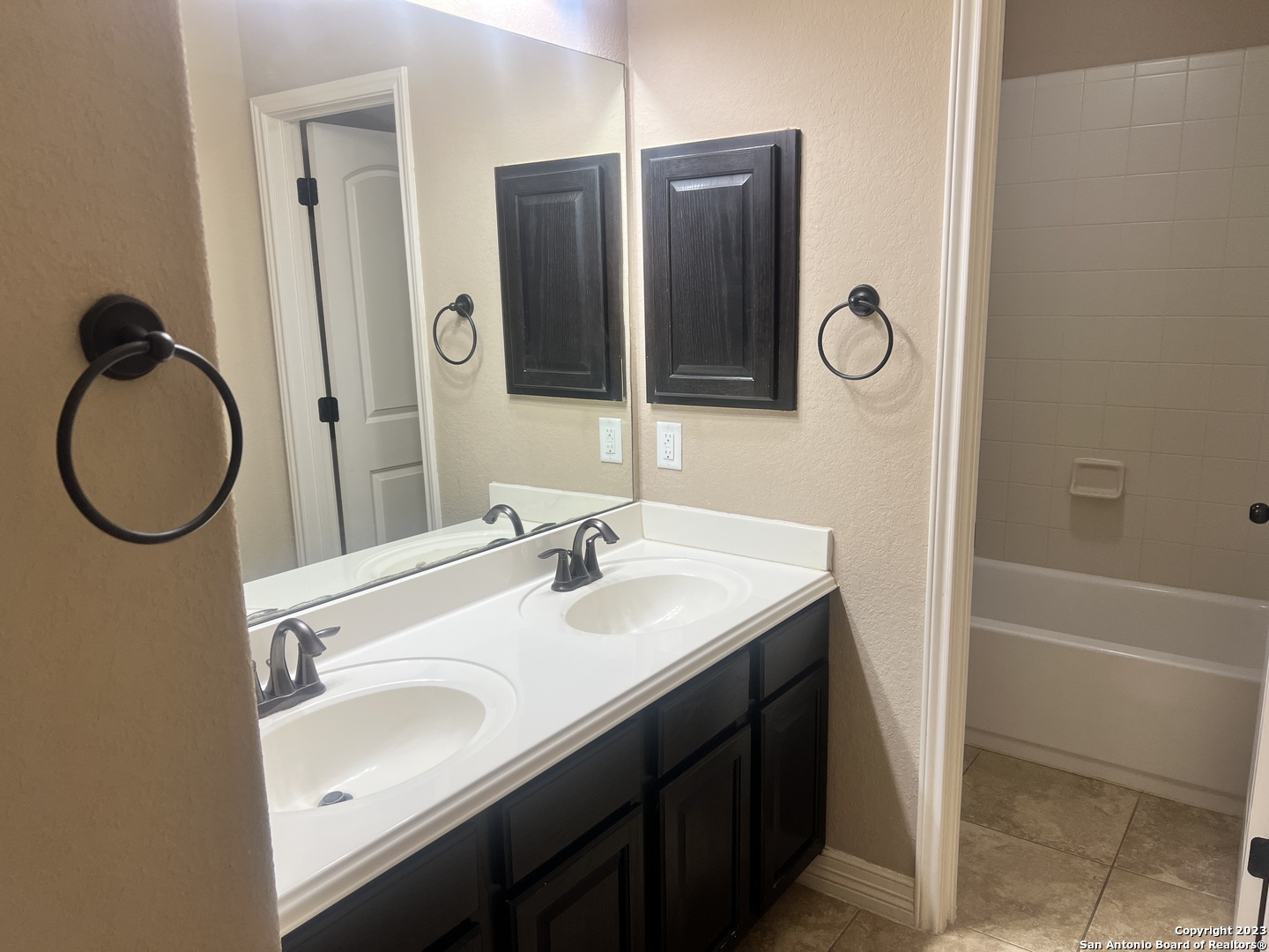 2431 Tremonto San Antonio, TX 78261 - Photo 12 of 21 a bathroom with a sink and a mirror