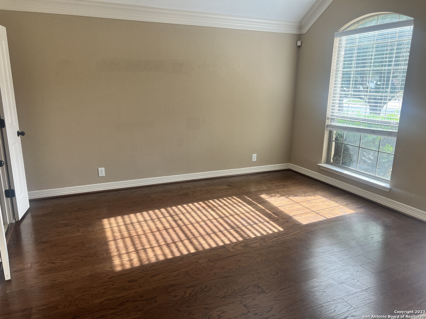 2431 Tremonto San Antonio, TX 78261 - Photo 3 of 21 a view of an empty room with wooden floor and a window