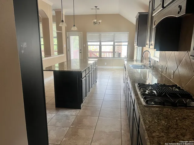 a kitchen with a refrigerator and a stove