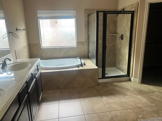 a bathroom with a tub sink and shower