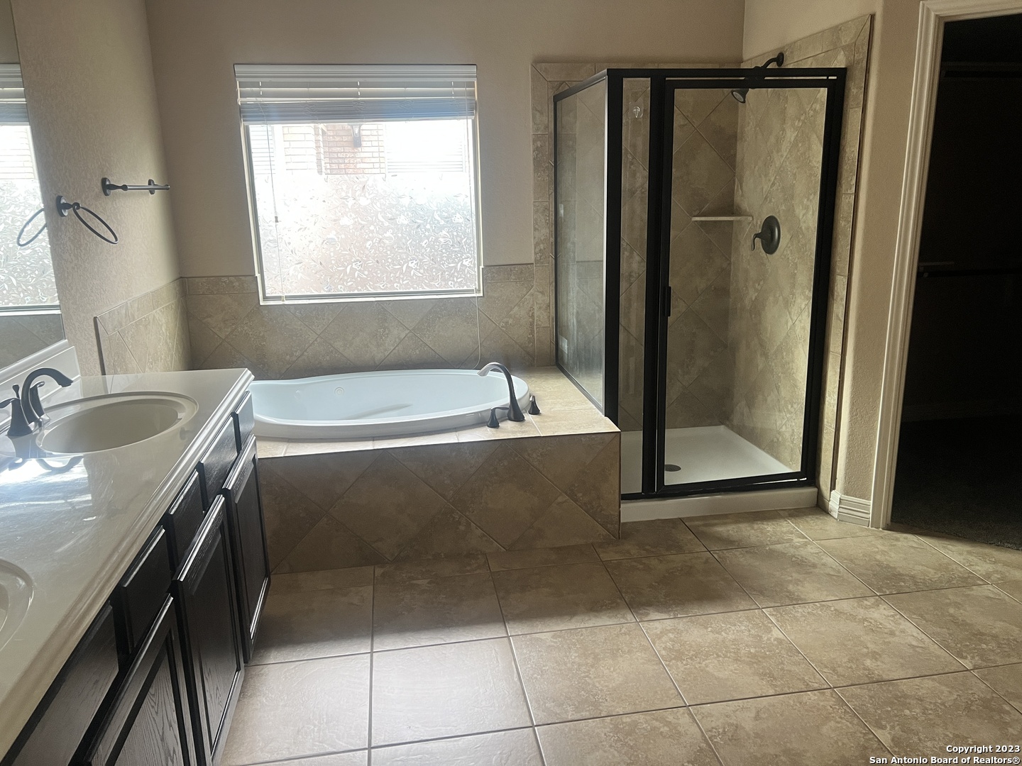 2431 Tremonto San Antonio, TX 78261 - Photo 9 of 21 a bathroom with a tub sink and shower