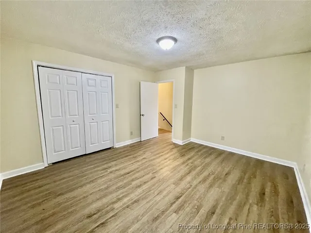 a view of an empty room and wooden floor