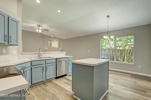 a kitchen with a sink and stove