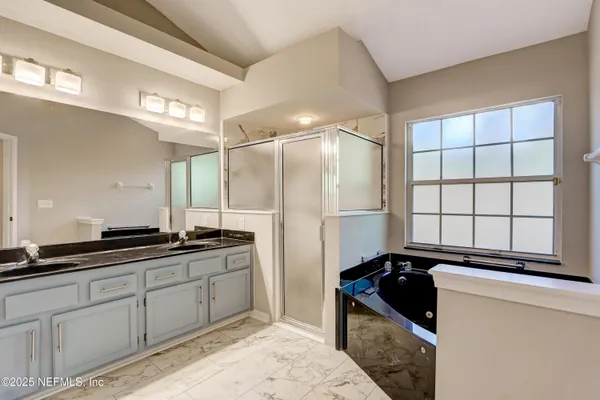 a kitchen with granite countertop a sink stove and refrigerator