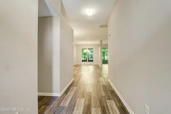 a view of gallery with wooden floor