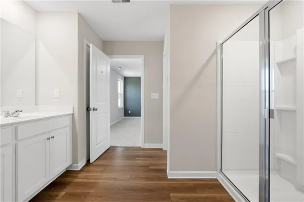 a bathroom with a glass shower door