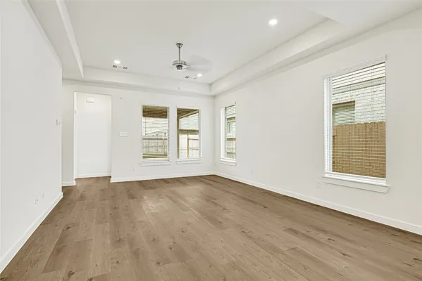 an empty room with a ceiling fan and a window