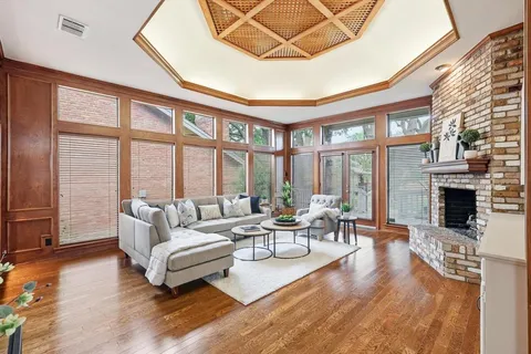 a living room with fireplace furniture and a large window