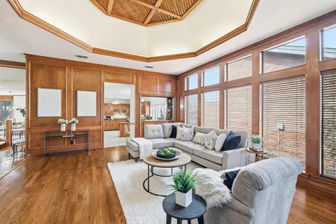 a living room with furniture and floor to ceiling windows
