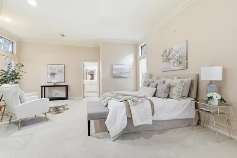 a spacious bedroom with a bed and window