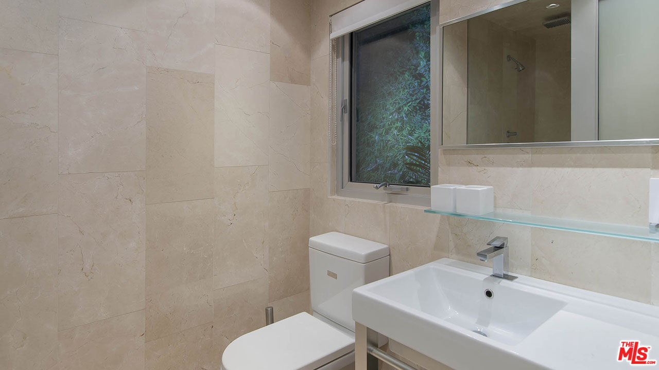 1466 Bel Air Road Los Angeles, CA 90077 - Photo 27 of 35 a bathroom with a sink a toilet and mirror