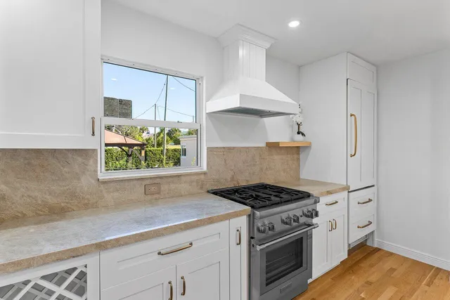 a kitchen with stainless steel appliances a stove a sink and a counter space