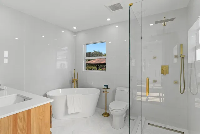 a bathroom with a toilet sink and shower