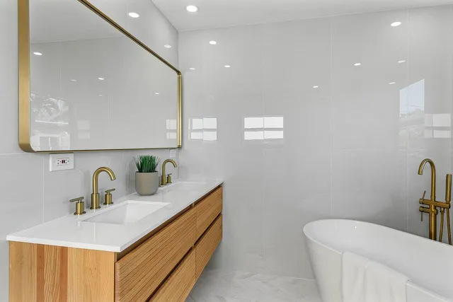 a bathroom with a sink a toilet and mirror