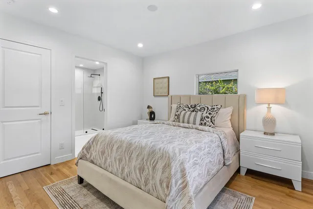 a bedroom with a bed and wooden floor