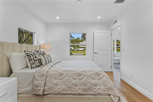 a bedroom with a bed and painting on the wall