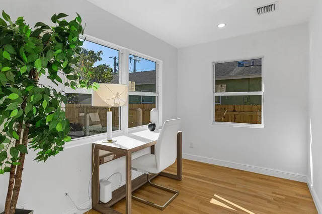 a view of a dining room with furniture and a potted plant