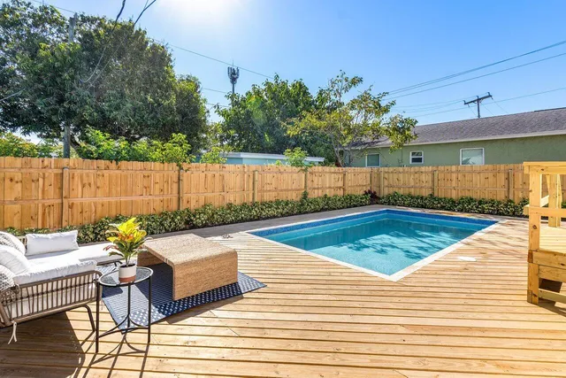 swimming pool view with a seating space