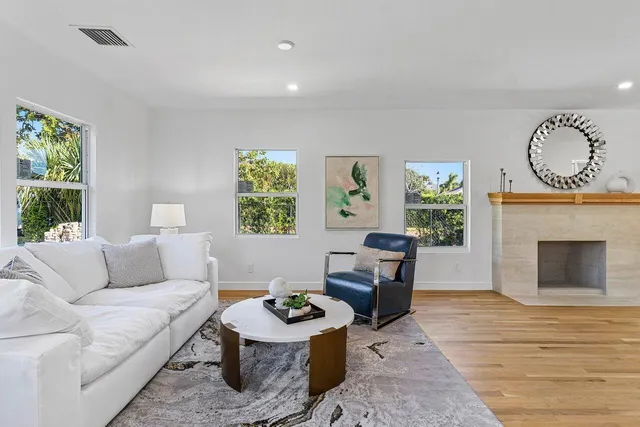 a living room with furniture a window and a fireplace