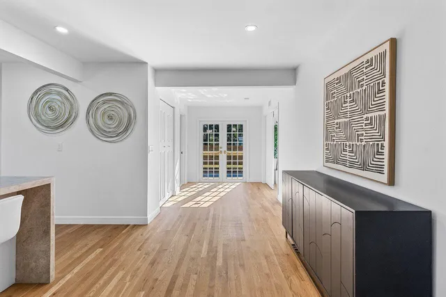 a view of a bedroom with wooden floor