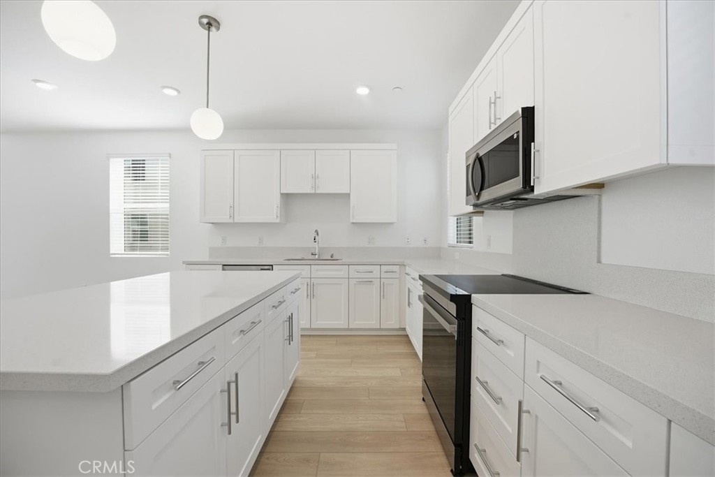 9324 Via Azul Pico Rivera, CA 90660 - Photo 11 of 33 a kitchen with cabinets appliances a sink and a counter top space