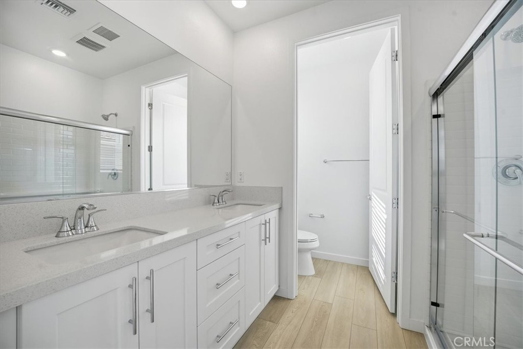 9324 Via Azul Pico Rivera, CA 90660 - Photo 15 of 33 a spacious bathroom with a double vanity sink a mirror and a toilet