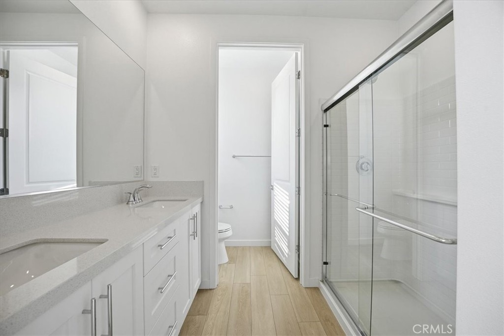 9324 Via Azul Pico Rivera, CA 90660 - Photo 16 of 33 a bathroom with a granite countertop sink a toilet and a shower