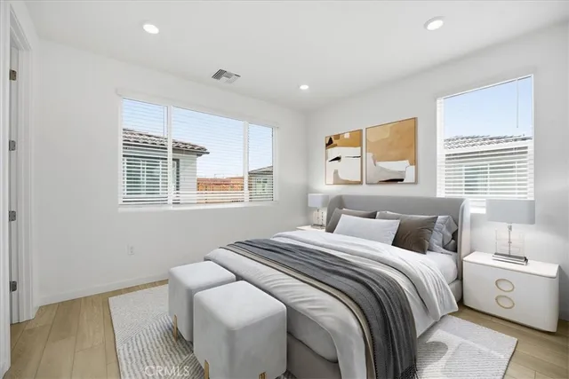 a bedroom with a large bed and a window